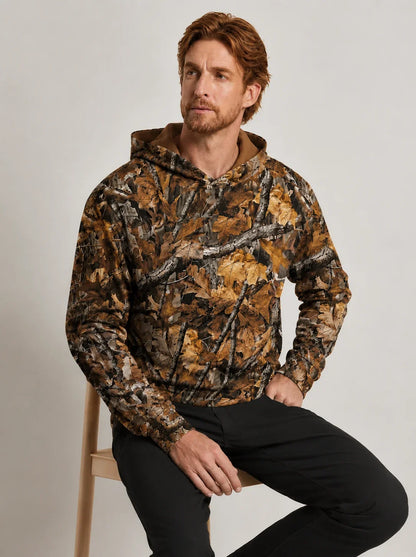 Man wearing a hooded long sleeve shirt with a brown and tan autumn leaf camouflage print.