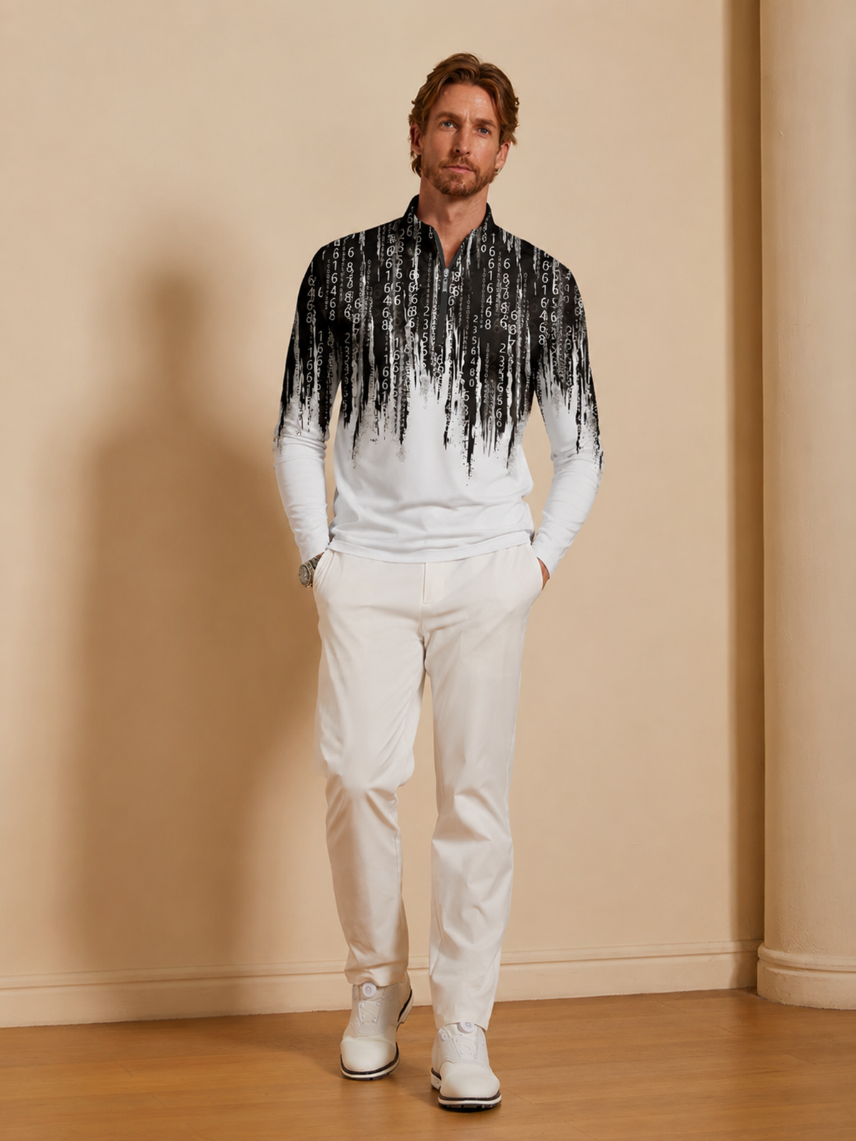 Man wearing a black and white digital print performance golf polo and white pants.