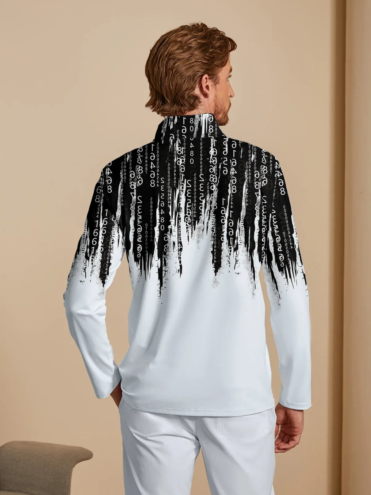 Rear view of a man wearing a white performance golf pullover with a black digital code print.