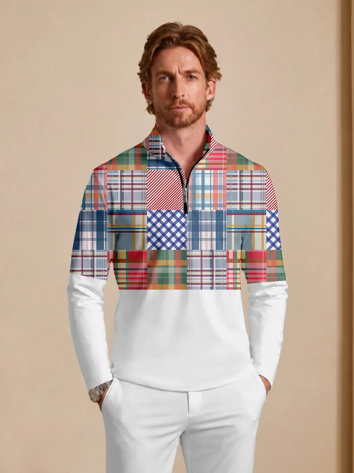 Man wearing a white and multi-colored patchwork plaid performance golf quarter-zip pullover.