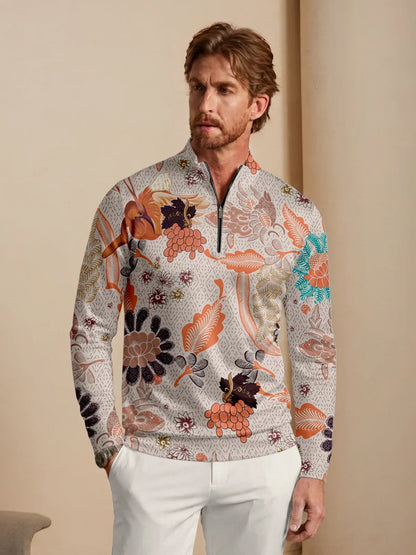 Man wearing a long-sleeve quarter-zip performance golf shirt with a bold botanical print.