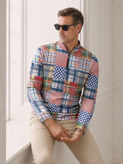 Man wearing a colorful multi-patterned patchwork quarter-zip golf shirt and khaki pants.