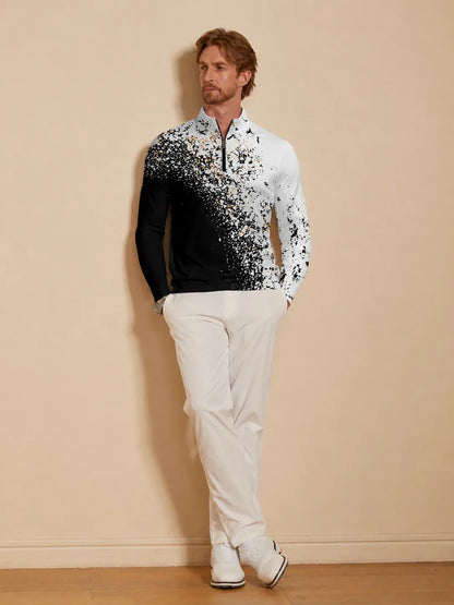 Man wearing a black and white splatter print quarter-zip golf shirt and white pants.